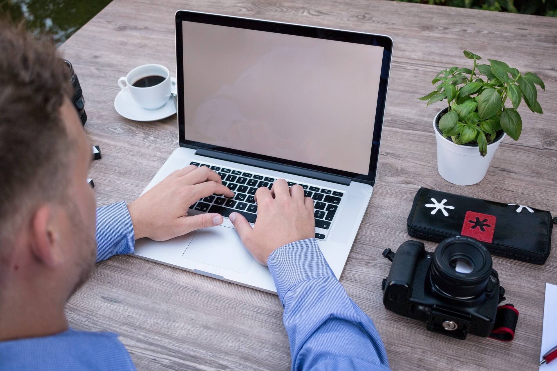 Person reviewing a financial plan with a calculator and laptop
